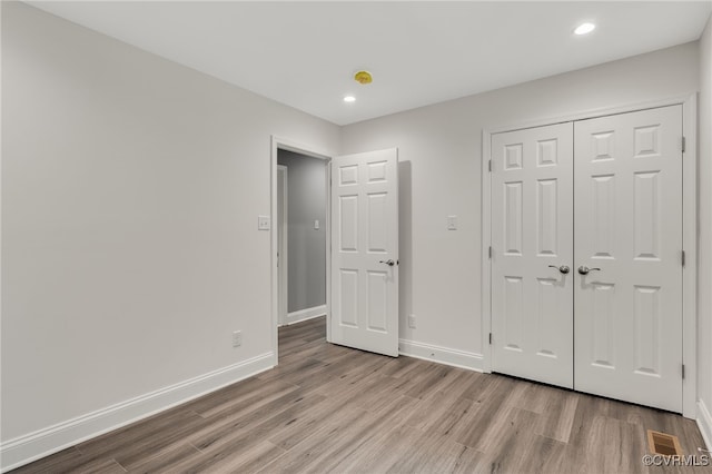 42 Mt Elba Rd, Columbia, VA 23038 - unfurnished bedroom with wood finished floors, baseboards, recessed lighting, and a closet