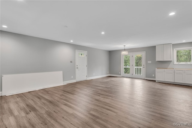 42 Mt Elba Rd, Columbia, VA 23038 - unfurnished living room featuring recessed lighting, light wood finished floors, baseboards, and a chandelier