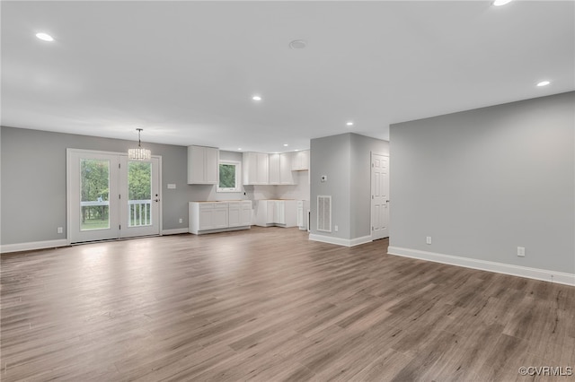 42 Mt Elba Rd, Columbia, VA 23038 - unfurnished living room with baseboards, light wood-style flooring, a chandelier, and recessed lighting
