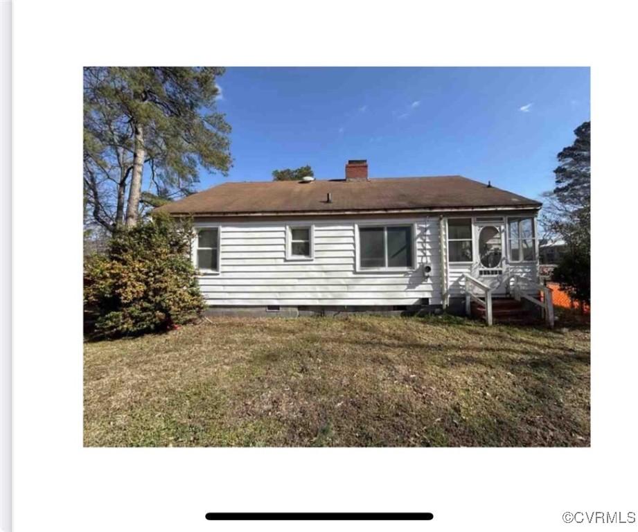 9310 Old Stage Hwy, Smithfield, VA 23430 - back of property with crawl space, a lawn, and a chimney
