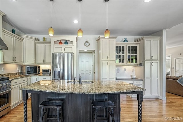 1729 Lake Forest Dr, Mineral, VA 23117 - kitchen featuring dark stone counters, hanging light fixtures, a sink, a breakfast bar, and stainless steel appliances