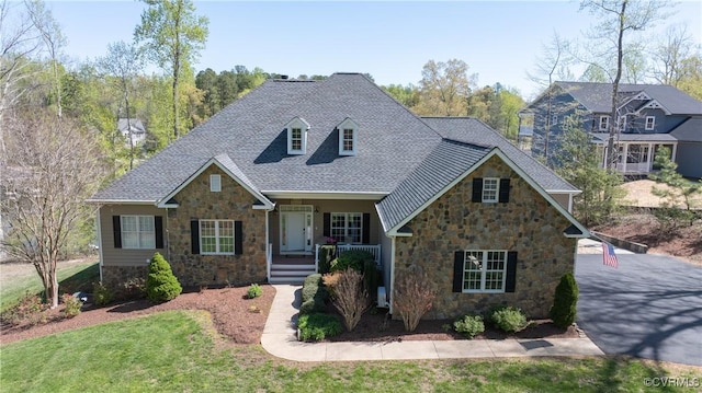 1729 Lake Forest Dr, Mineral, VA 23117 - craftsman-style home with stone siding, a shingled roof, covered porch, and a front yard