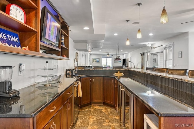 1729 Lake Forest Dr, Mineral, VA 23117 - kitchen with a sink, dark stone countertops, ceiling fan, open shelves, and beverage cooler
