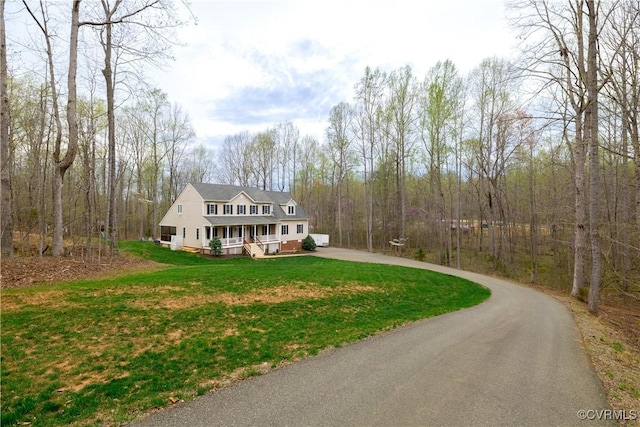 1635 Dorset Meadows Ln, Powhatan, VA 23139 - view of front facade featuring covered porch, asphalt driveway, a front yard, and a view of trees