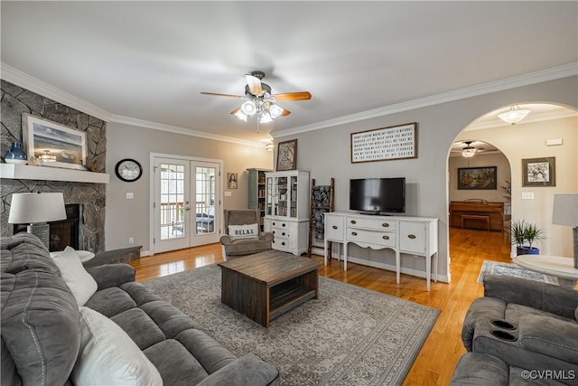 1635 Dorset Meadows Ln, Powhatan, VA 23139 - living room featuring a ceiling fan, arched walkways, crown molding, light wood-type flooring, and french doors