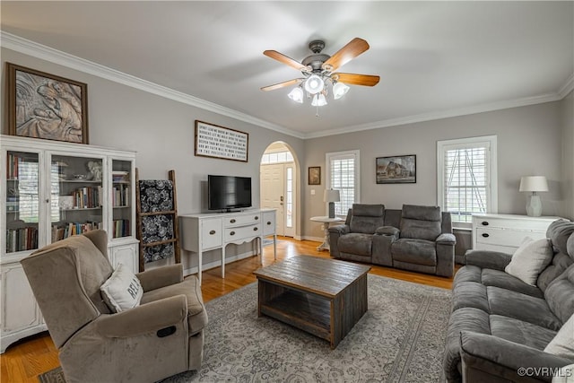 1635 Dorset Meadows Ln, Powhatan, VA 23139 - living area featuring crown molding, light wood-type flooring, a ceiling fan, plenty of natural light, and arched walkways