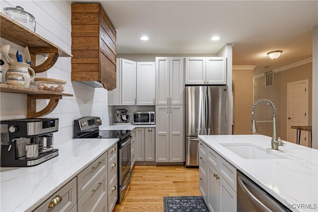 1635 Dorset Meadows Ln, Powhatan, VA 23139 - kitchen featuring appliances with stainless steel finishes, open shelves, crown molding, decorative backsplash, and light wood finished floors