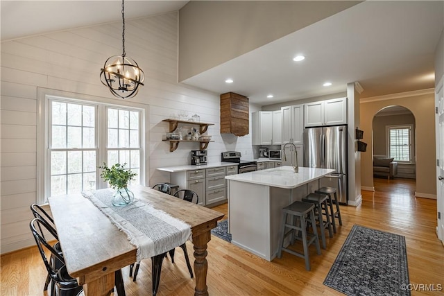 1635 Dorset Meadows Ln, Powhatan, VA 23139 - kitchen featuring stainless steel appliances, arched walkways, a chandelier, light countertops, and ornamental molding
