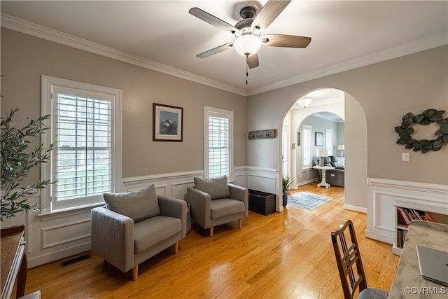 1635 Dorset Meadows Ln, Powhatan, VA 23139 - living area featuring arched walkways, ceiling fan, crown molding, a wainscoted wall, and light wood-style floors