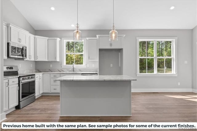 5782 Darlington Heights Rd, Farmville, VA 23901 - kitchen featuring stainless steel appliances, white cabinets, a kitchen island, light wood-type flooring, and recessed lighting