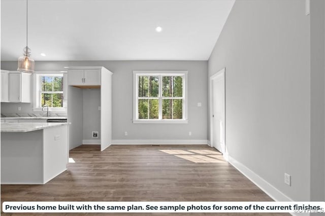 5782 Darlington Heights Rd, Farmville, VA 23901 - kitchen featuring white cabinetry, light stone counters, wood finished floors, recessed lighting, and hanging light fixtures