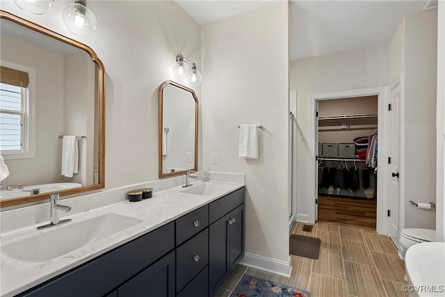 703 W Vaughan Rd, Hanover, VA 23005 - bathroom with a shower stall, double vanity, and a walk in closet