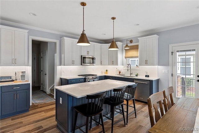 703 W Vaughan Rd, Hanover, VA 23005 - kitchen with stainless steel appliances, decorative backsplash, plenty of natural light, wood finished floors, and ornamental molding