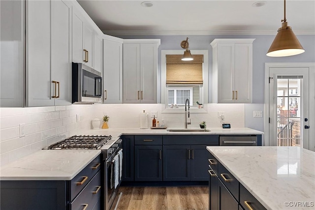 703 W Vaughan Rd, Hanover, VA 23005 - kitchen featuring stainless steel appliances, white cabinets, backsplash, light stone countertops, and crown molding