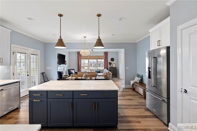 703 W Vaughan Rd, Hanover, VA 23005 - kitchen with appliances with stainless steel finishes, white cabinetry, dark wood-style floors, crown molding, and pendant lighting