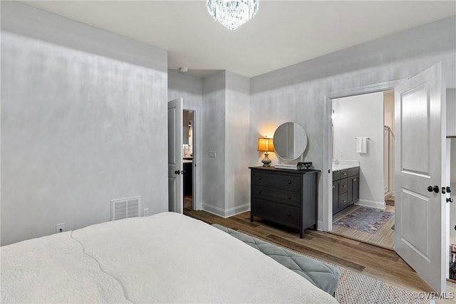 703 W Vaughan Rd, Hanover, VA 23005 - bedroom with wood finished floors and ensuite bath