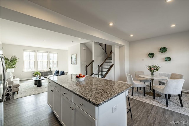 6328 Gossamer Aly, Moseley, VA 23120 - kitchen featuring stone countertops, open floor plan, dark wood-style floors, and a kitchen island