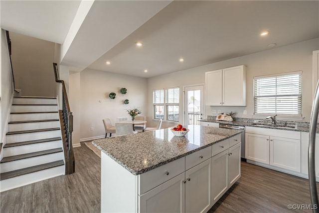 6328 Gossamer Aly, Moseley, VA 23120 - kitchen with stainless steel dishwasher, dark wood finished floors, white cabinetry, a kitchen island, and a sink