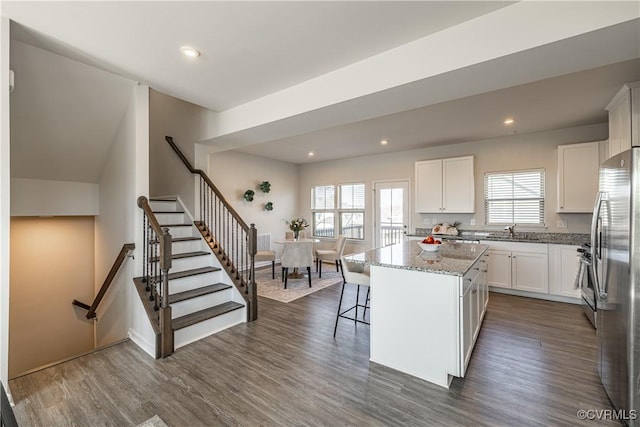 6328 Gossamer Aly, Moseley, VA 23120 - kitchen featuring a sink, appliances with stainless steel finishes, dark wood-type flooring, a kitchen island, and light stone counters