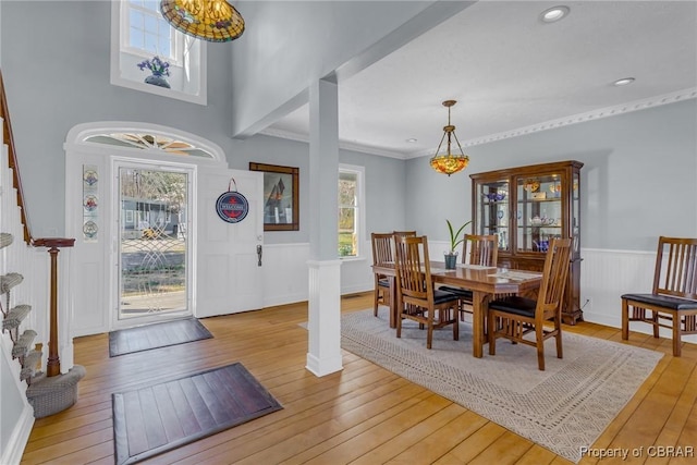289 Oyster Shell Rd, Laneview, VA 22560 - dining room featuring stairway, light wood-type flooring, a wainscoted wall, and ornamental molding