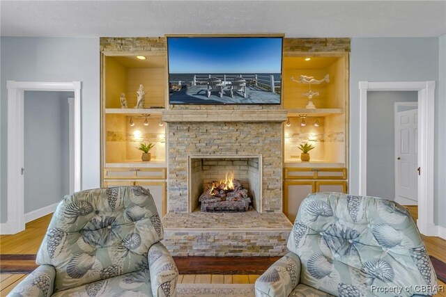 289 Oyster Shell Rd, Laneview, VA 22560 - sitting room featuring baseboards, wood finished floors, built in features, and a fireplace
