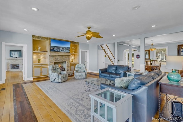 289 Oyster Shell Rd, Laneview, VA 22560 - living area with a fireplace, hardwood / wood-style flooring, a ceiling fan, stairs, and recessed lighting