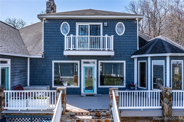 289 Oyster Shell Rd, Laneview, VA 22560 - view of front of home with a balcony, a chimney, a shingled roof, and a deck