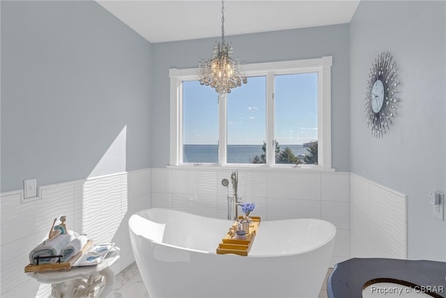 289 Oyster Shell Rd, Laneview, VA 22560 - bathroom with tile walls, a chandelier, marble finish floors, wainscoting, and a soaking tub