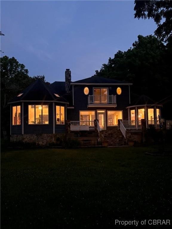 289 Oyster Shell Rd, Laneview, VA 22560 - back of house featuring a balcony, a chimney, and a lawn