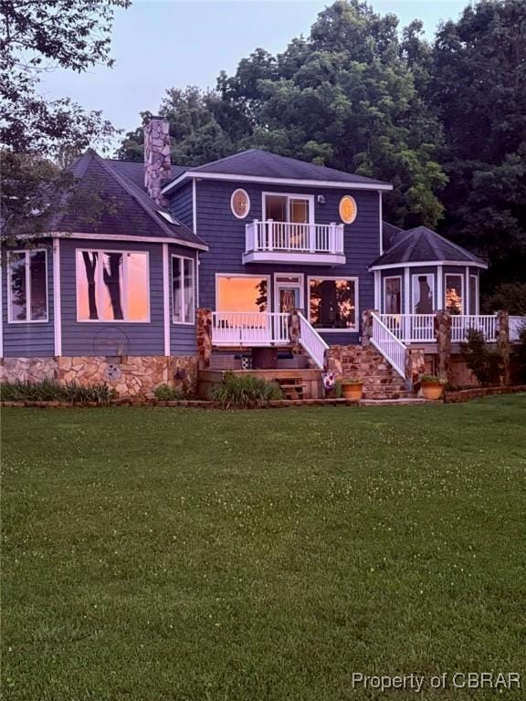 289 Oyster Shell Rd, Laneview, VA 22560 - back of property featuring a balcony, a chimney, a lawn, and a deck