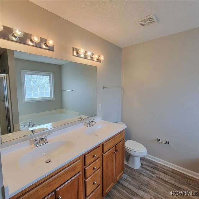6118 Pond Grass Rd, Mechanicsville, VA 23111 - full bath with wood finished floors, a sink, toilet, and visible vents