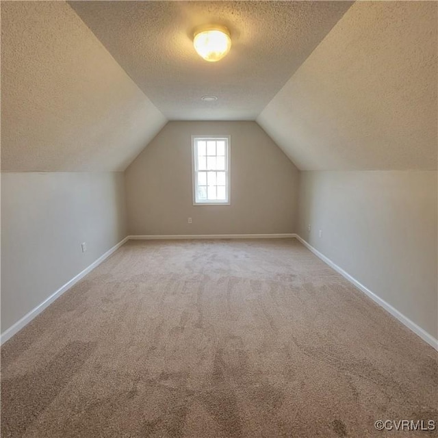 6118 Pond Grass Rd, Mechanicsville, VA 23111 - bonus room featuring baseboards, lofted ceiling, carpet, and a textured ceiling