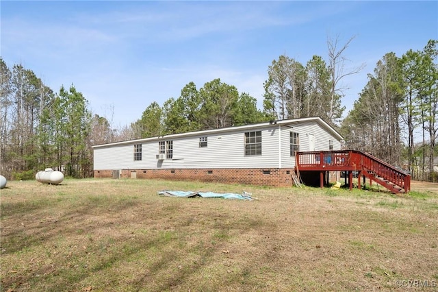 rear view of property featuring crawl space, a yard, a deck, and stairs