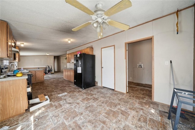 kitchen with ceiling fan, light countertops, electric stove, brown cabinets, and black refrigerator with ice dispenser