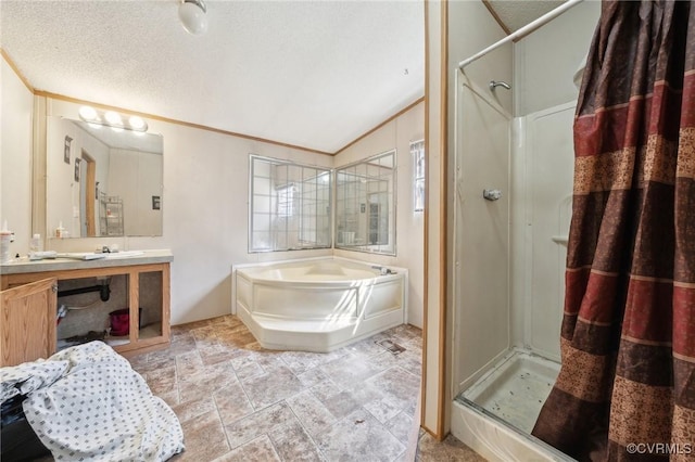 bathroom featuring vanity, a garden tub, a stall shower, and a textured ceiling
