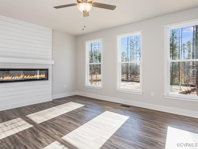 LOT73 Dove Ct, Louisa, VA 23024 - unfurnished living room with visible vents, a ceiling fan, a glass covered fireplace, wood finished floors, and baseboards