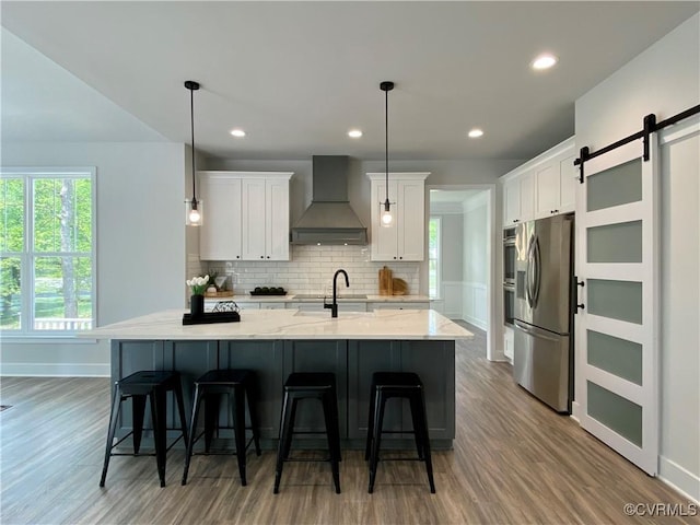 LOT73 Dove Ct, Louisa, VA 23024 - kitchen with premium range hood, backsplash, white cabinetry, a barn door, and stainless steel fridge with ice dispenser