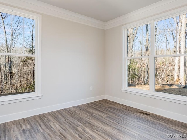 LOT73 Dove Ct, Louisa, VA 23024 - spare room with crown molding, wood finished floors, baseboards, and visible vents