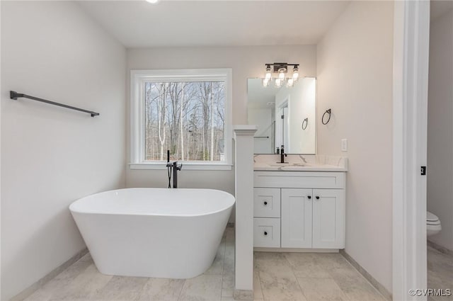LOT73 Dove Ct, Louisa, VA 23024 - full bath featuring a soaking tub, toilet, vanity, and baseboards