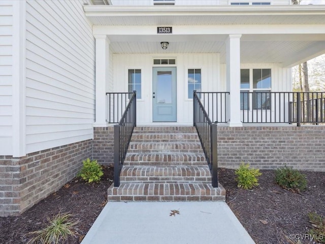 doorway to property featuring board and batten siding and a porch