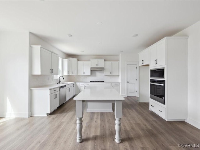 kitchen with white cabinets, light countertops, and stainless steel appliances