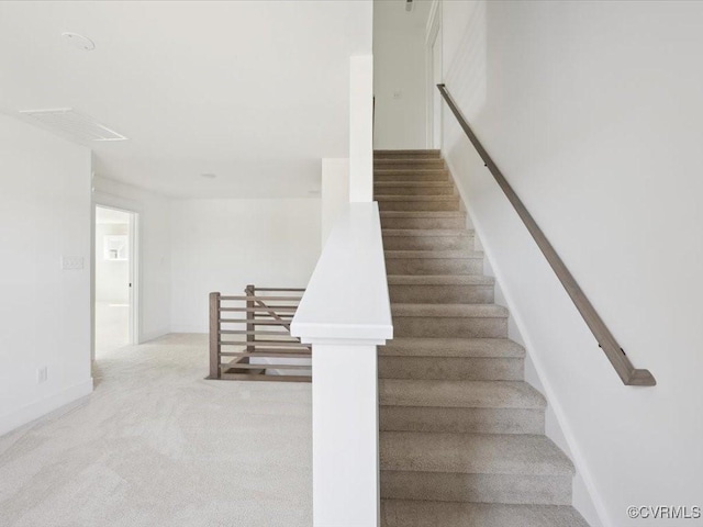 staircase with carpet floors and baseboards