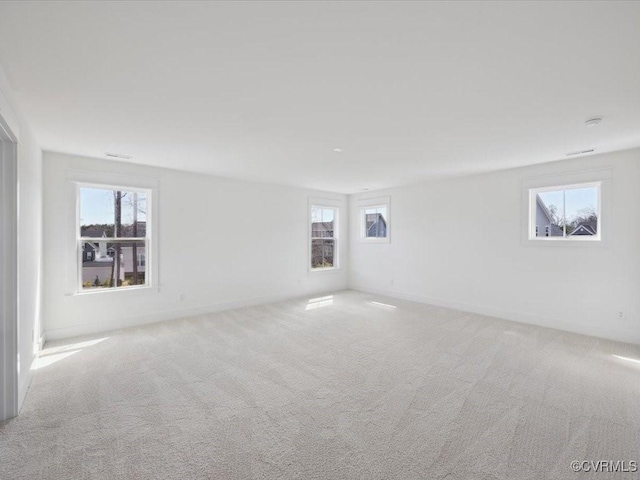 unfurnished room with baseboards and carpet flooring