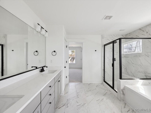 bathroom featuring a marble finish shower, marble finish floor, a sink, and plenty of natural light