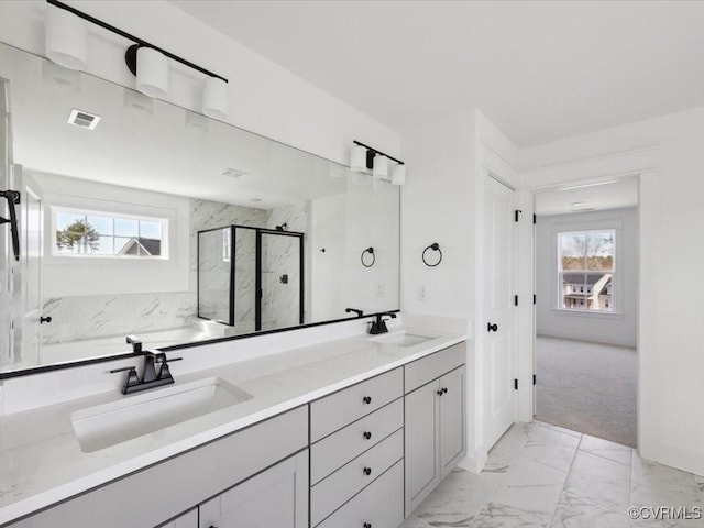 full bath featuring marble finish floor, visible vents, a sink, and a wealth of natural light