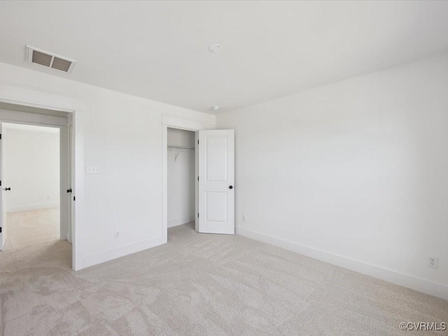 unfurnished bedroom featuring carpet floors, a closet, baseboards, and visible vents