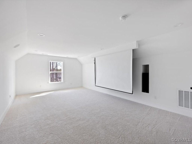 bonus room with visible vents, lofted ceiling, and carpet flooring
