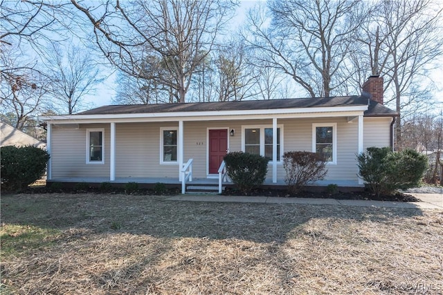 single story home with a porch and a chimney