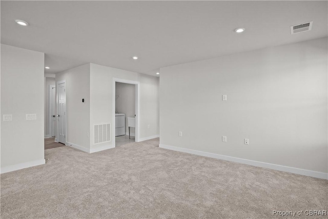 93 Grace Hill Cir, Kilmarnock, VA 22482 - spare room featuring light carpet, visible vents, recessed lighting, and washer / dryer