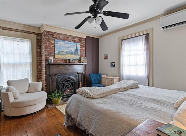 2515 E Grace St, Richmond, VA 23223 - bedroom with crown molding, hardwood / wood-style flooring, a wall mounted air conditioner, and ceiling fan